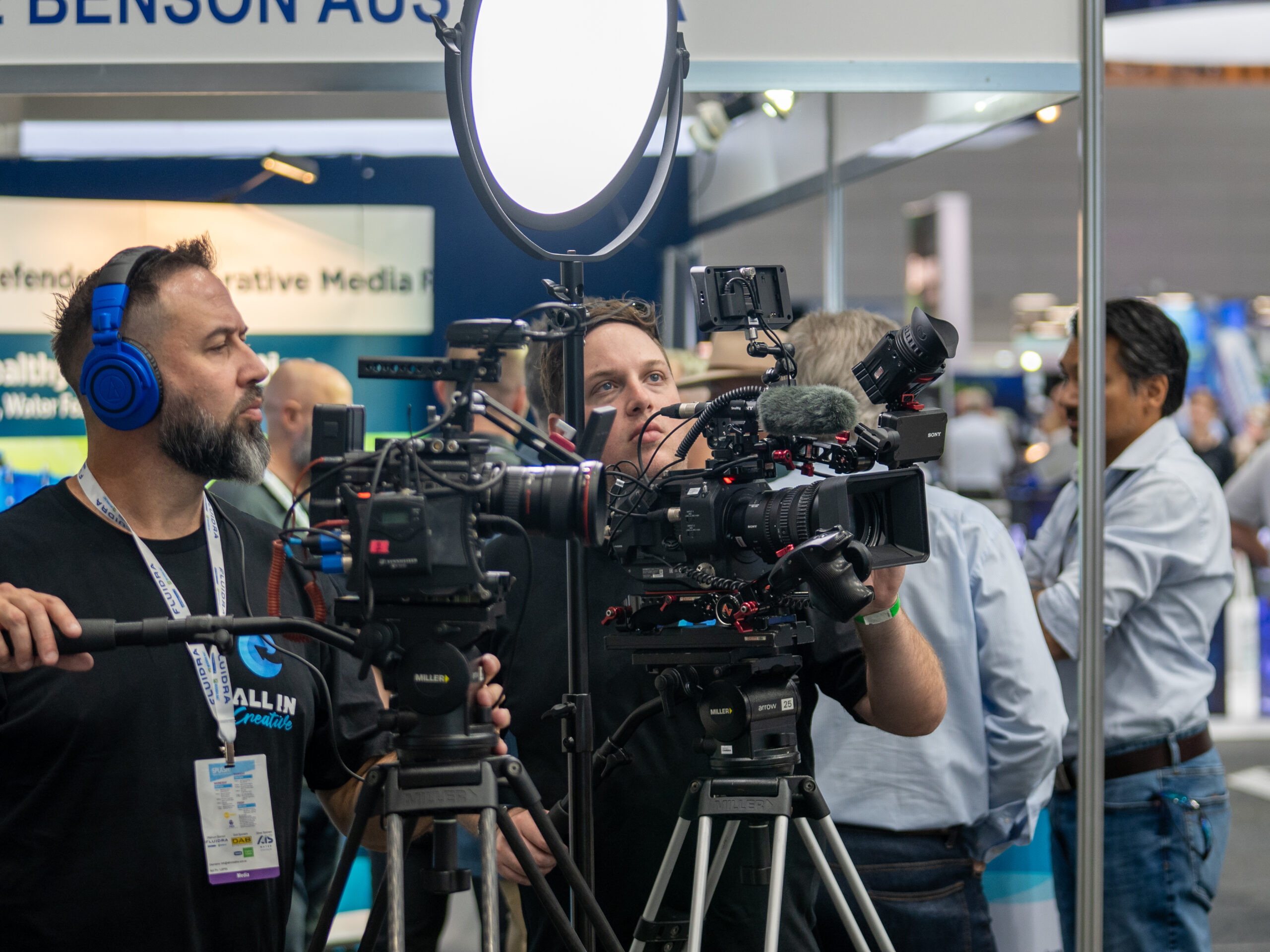 Video team using lights and cameras to film content for websites and social media including Facebook, Instagram and LinkedIn at a large business expo